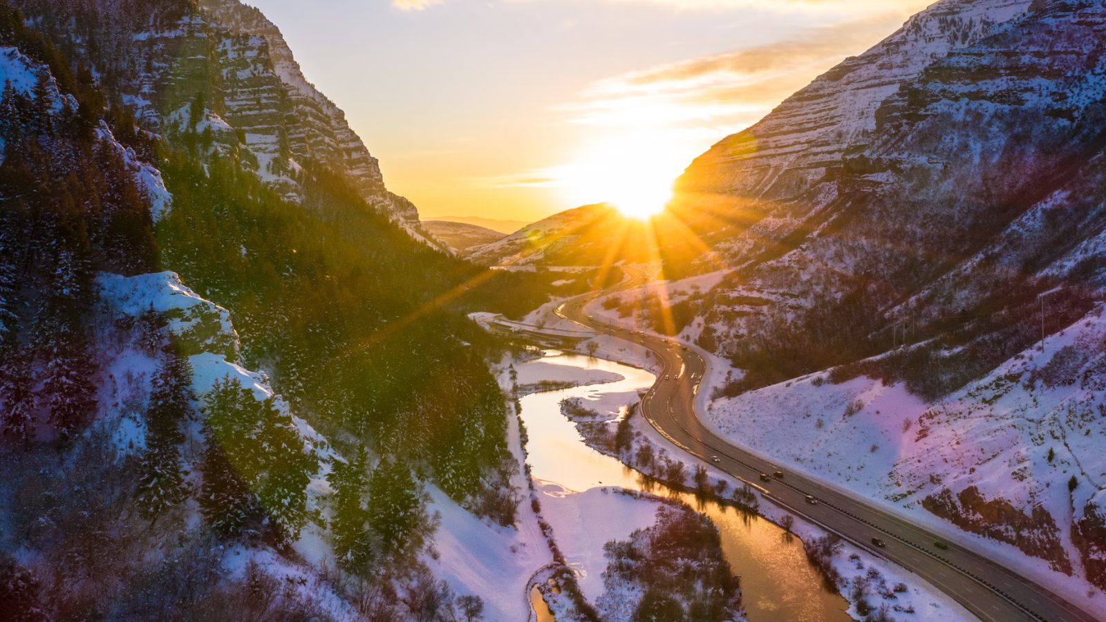 The sun sets over the river in Provo, Utah