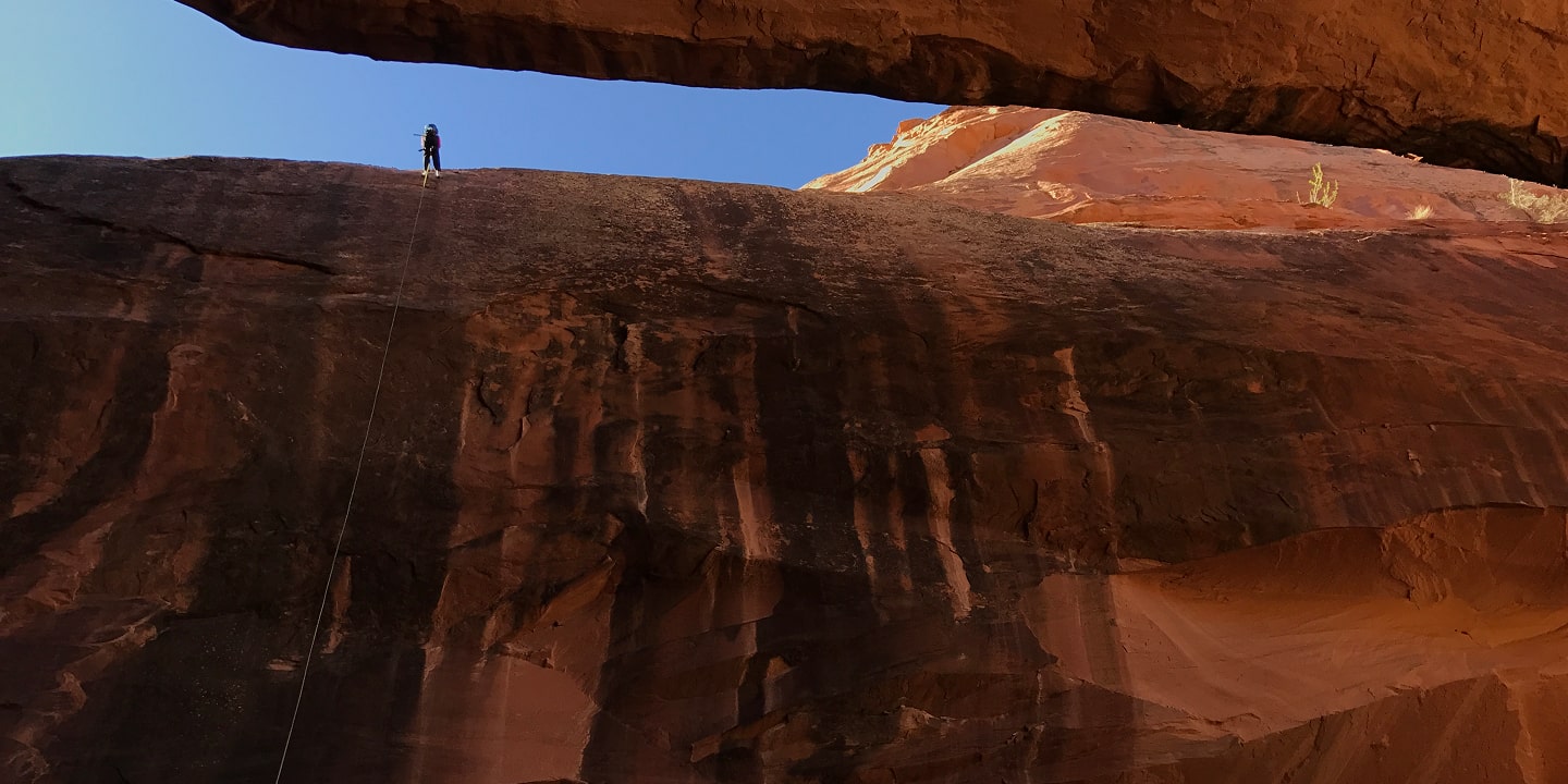A person stands at the very top of the medieval chamber in moab
