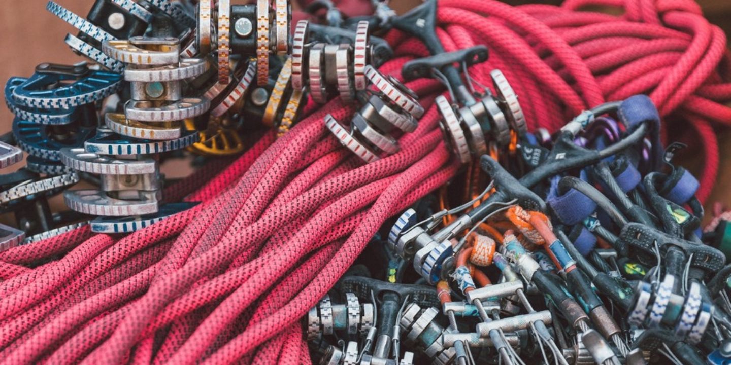 A large pile of trad climbing gear