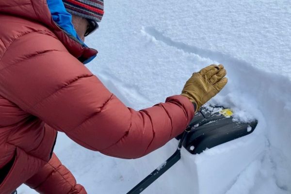 a man practices avalanche assessment techniques