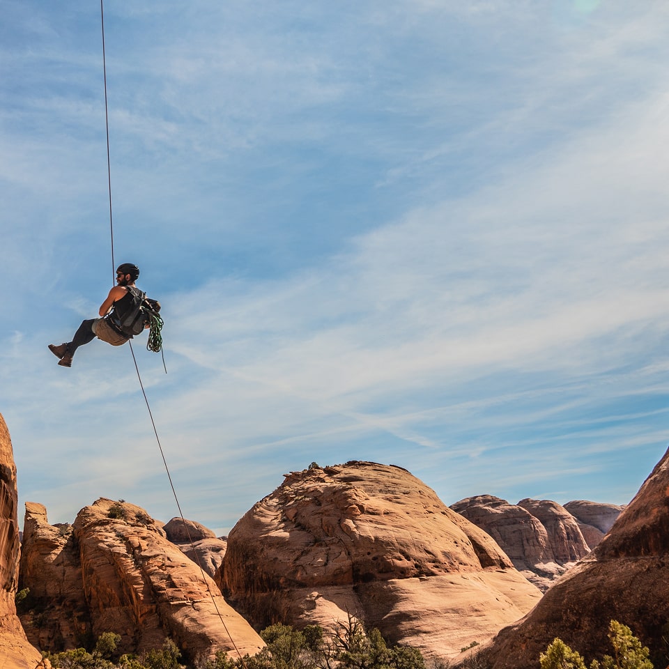 guy repelling while canyoneering