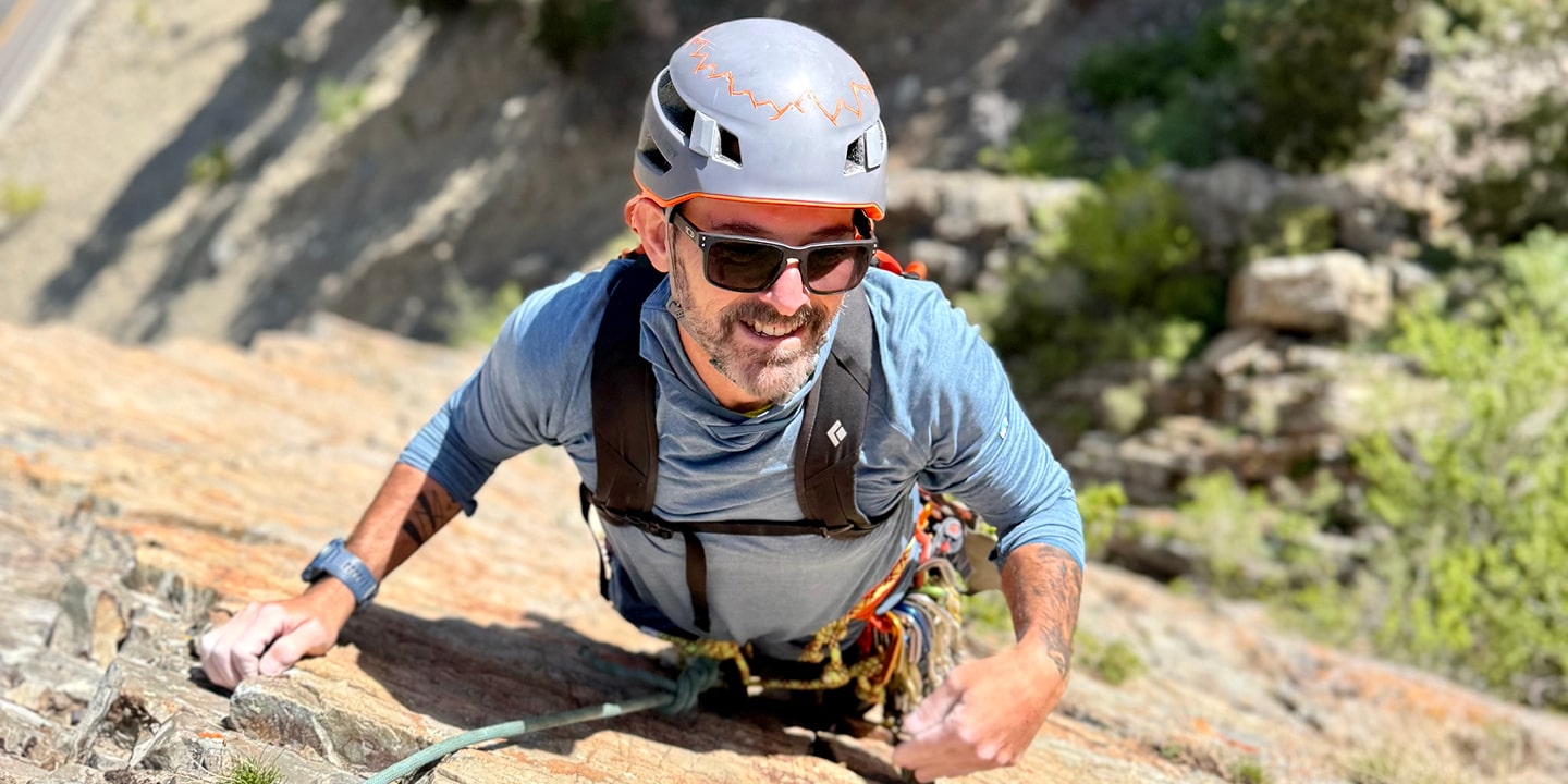 A man pauses while learning to multi-pitch climb