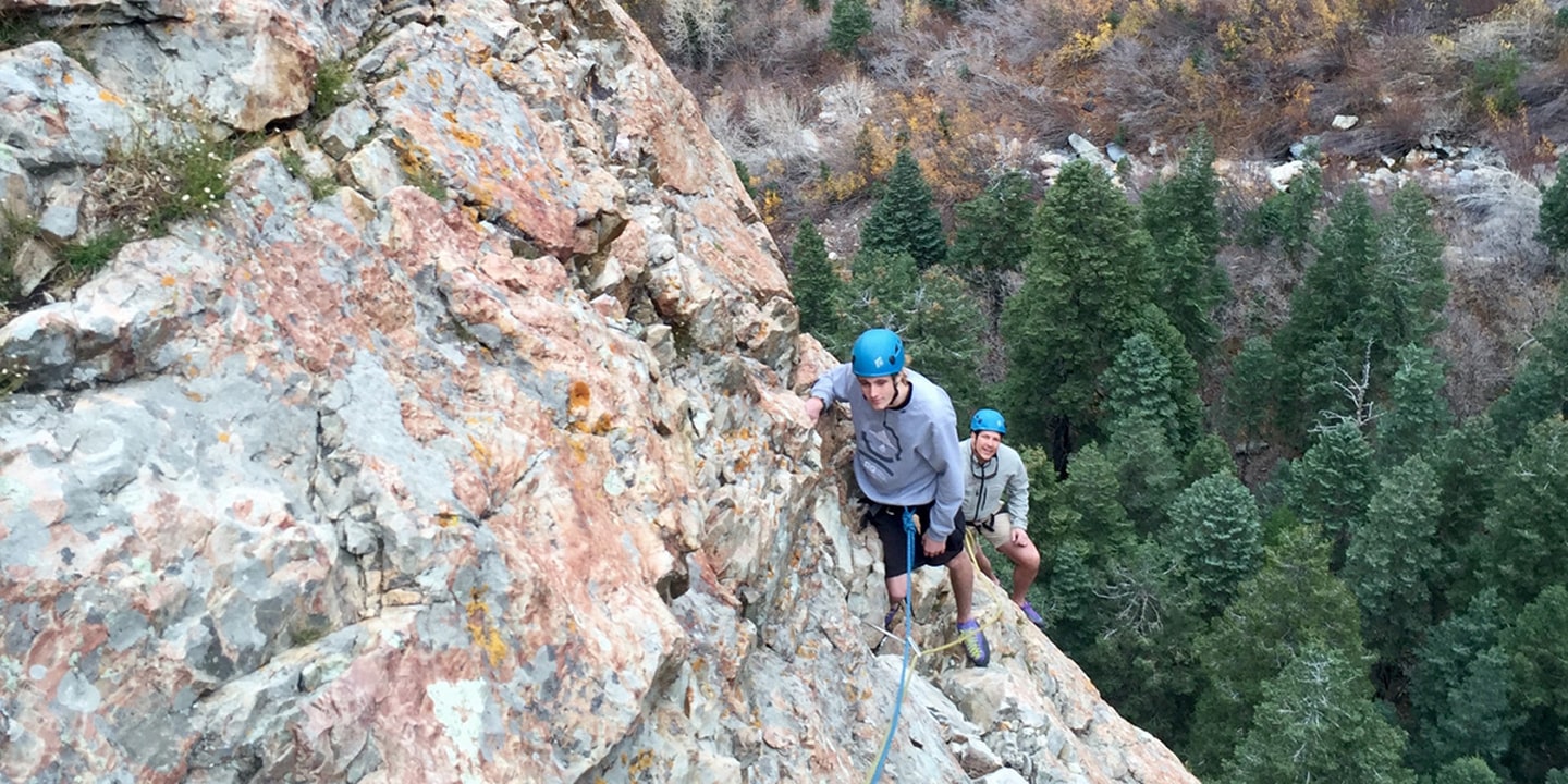 People completing a multi-pitch climb route