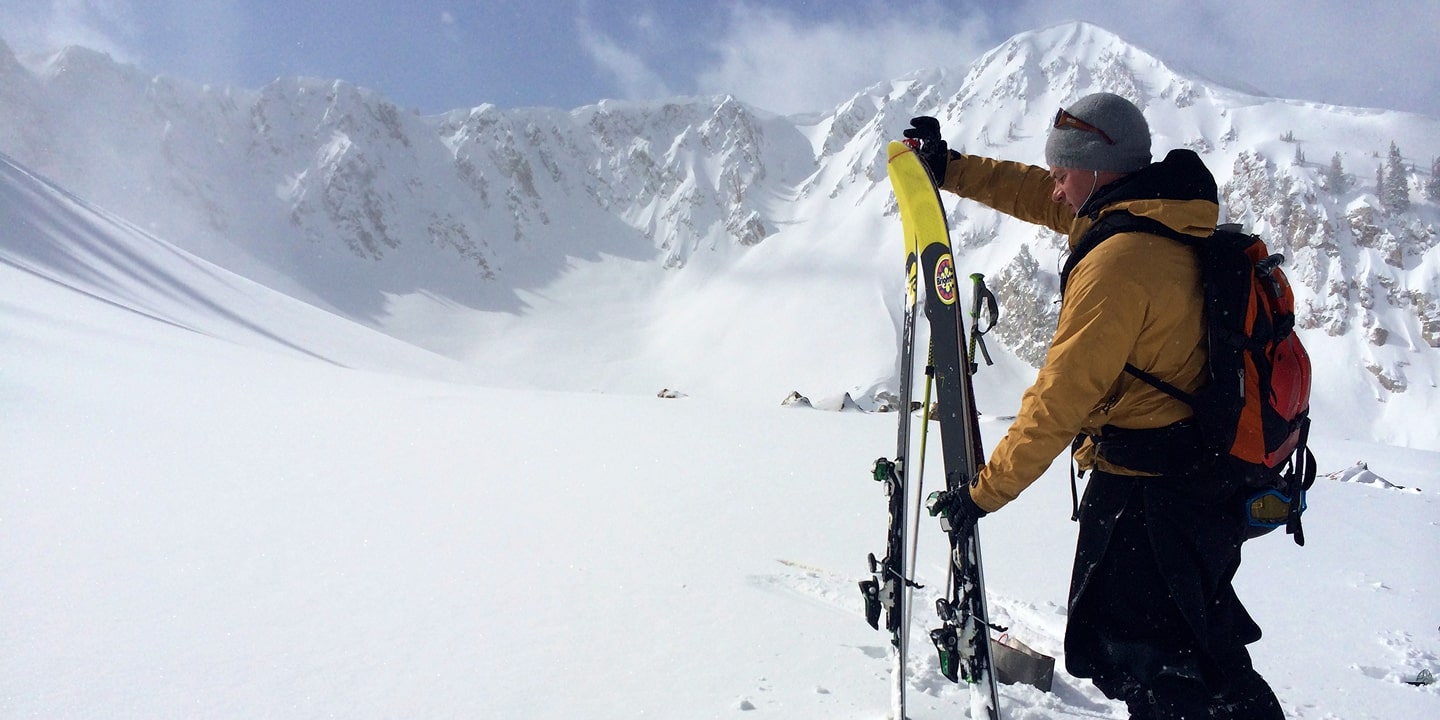 A man removed his skins while backcountry skiing