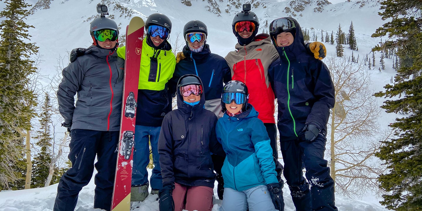 A group of people wearing ski gear smile for a photo