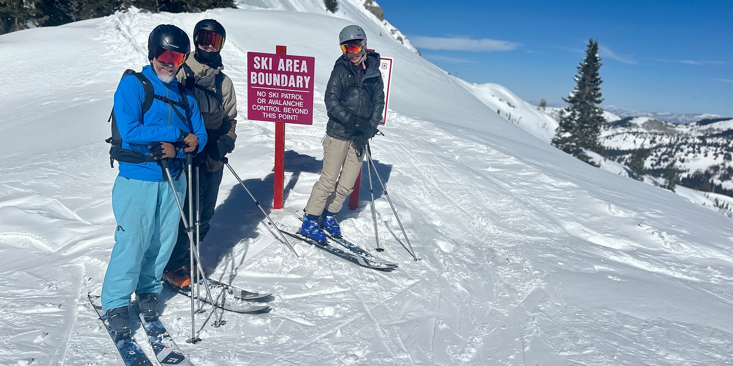 three people guided skiing