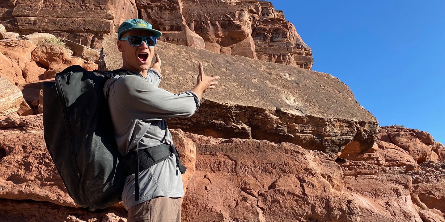 A man in front of the bow and arrow canyon in moab