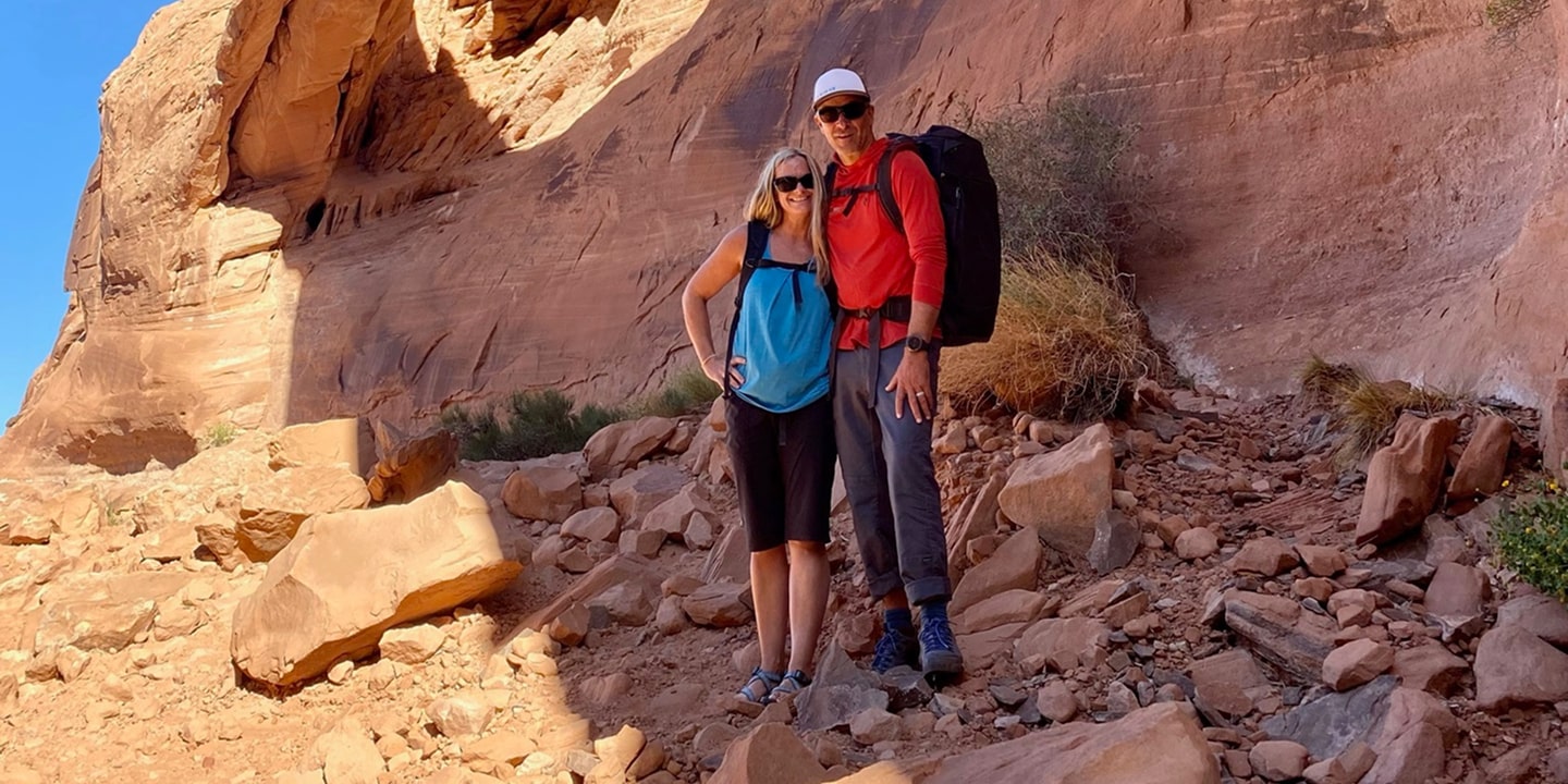 A man and woman in bow and arrow canyon in moab