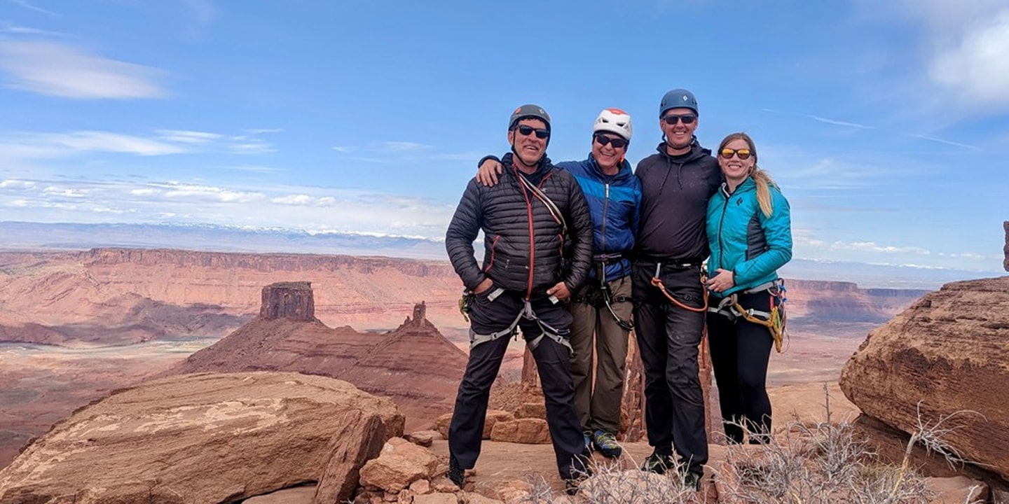 Four people in rock climbing gear