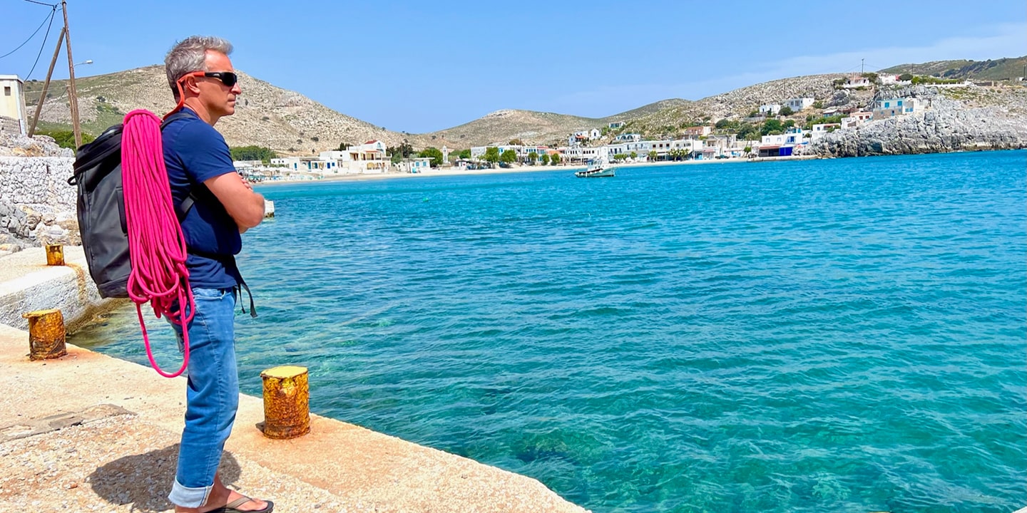 man on a dock with rock climbing rope