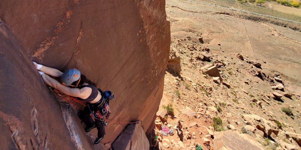 A person crack climbs in moab utah