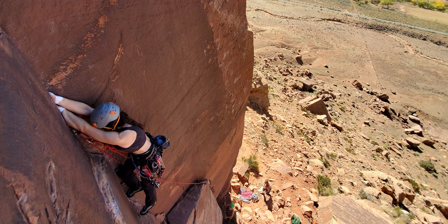 A person crack climbs in moab utah