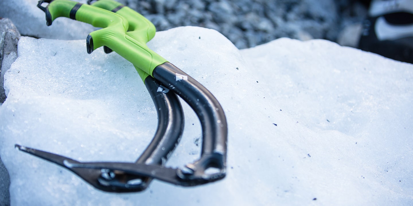 Two green ice axes lay on ice