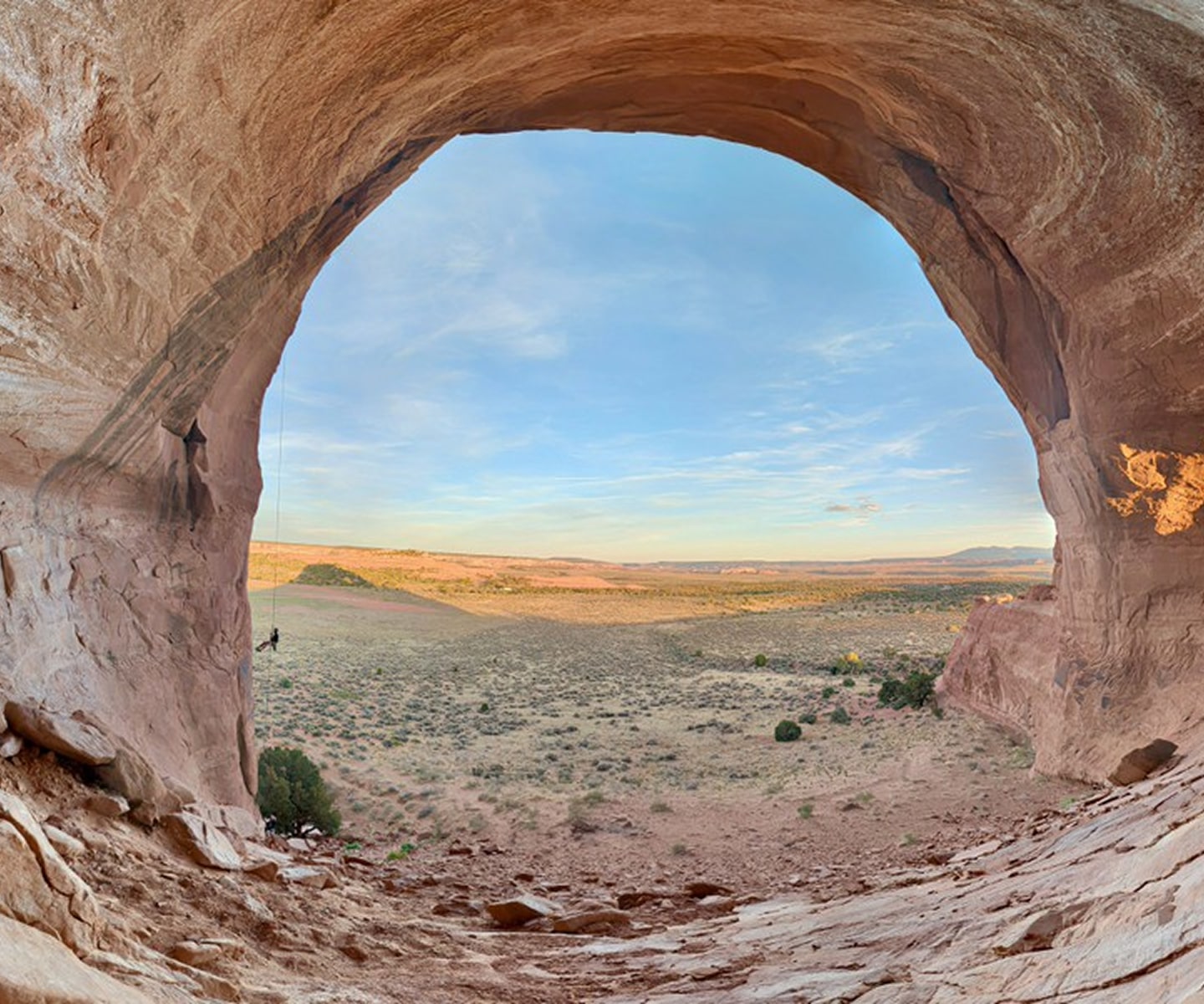 person repelling down a unique rock formation