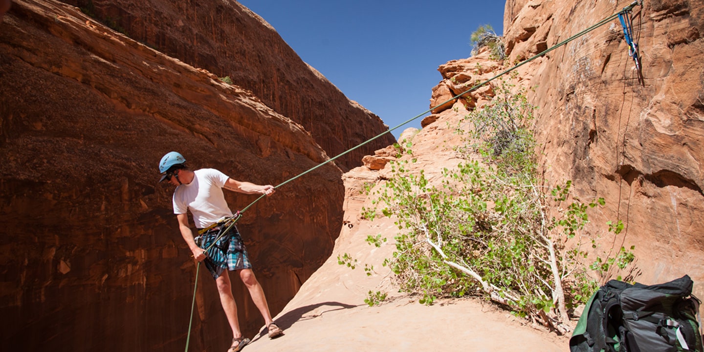 A man repares to canyoneer in moab