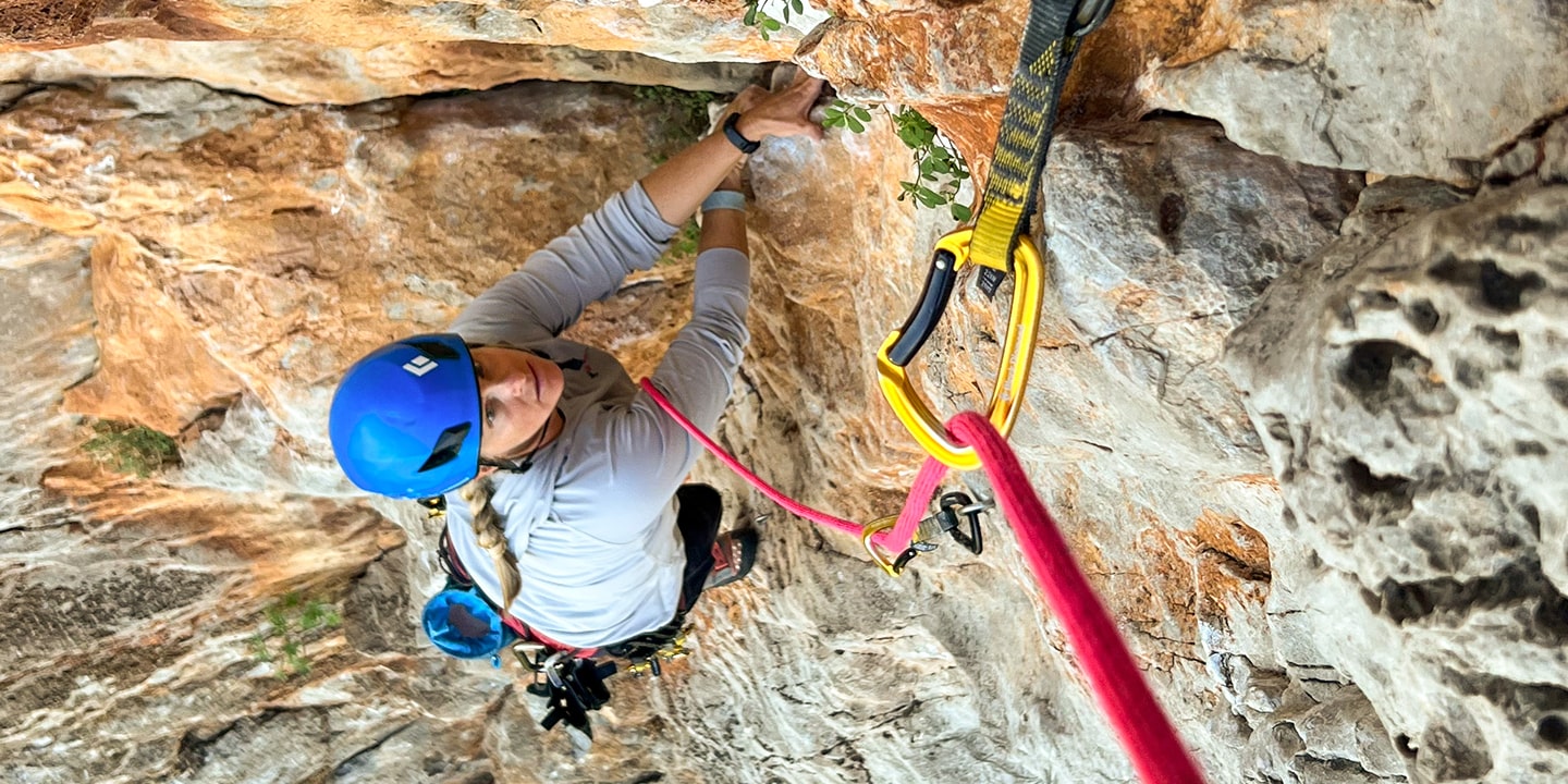 women cleaning a rock climbing route