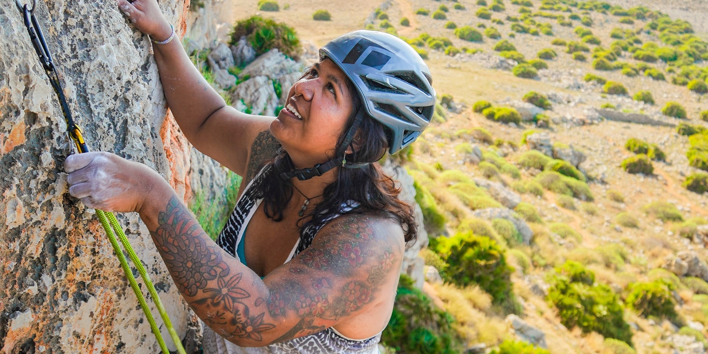 woman lead climbing a rock route on Sicily rock climbing trip