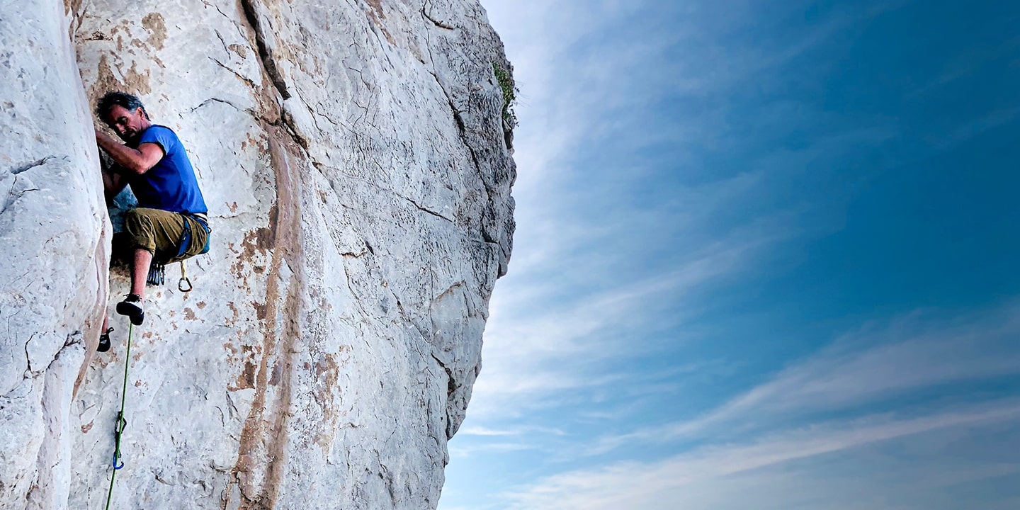 man lead climbing a tough route in Sicily