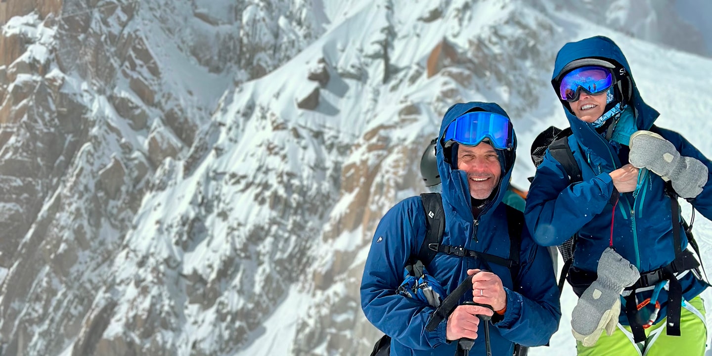 A man smiles in ski gear while skiing in chamonix