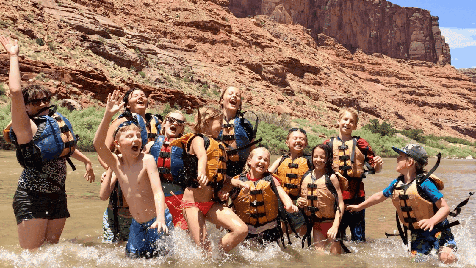 group of young rafters having fun during a low water rafting time in moab