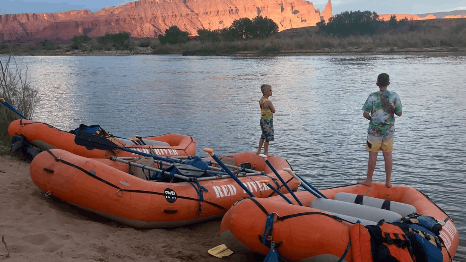 two young rafters assessing moab water levels in utah