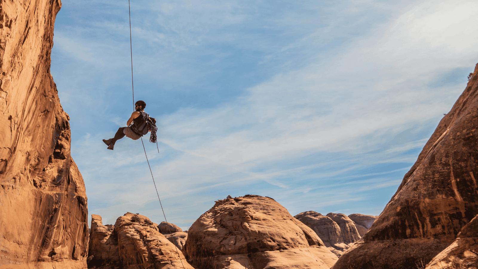 person rappelling on a canyoneering trip outside of moab utah