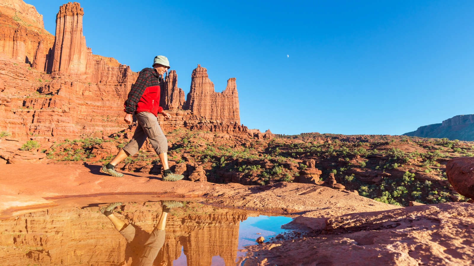 a man hikes the Fisher Towers trail in Moab