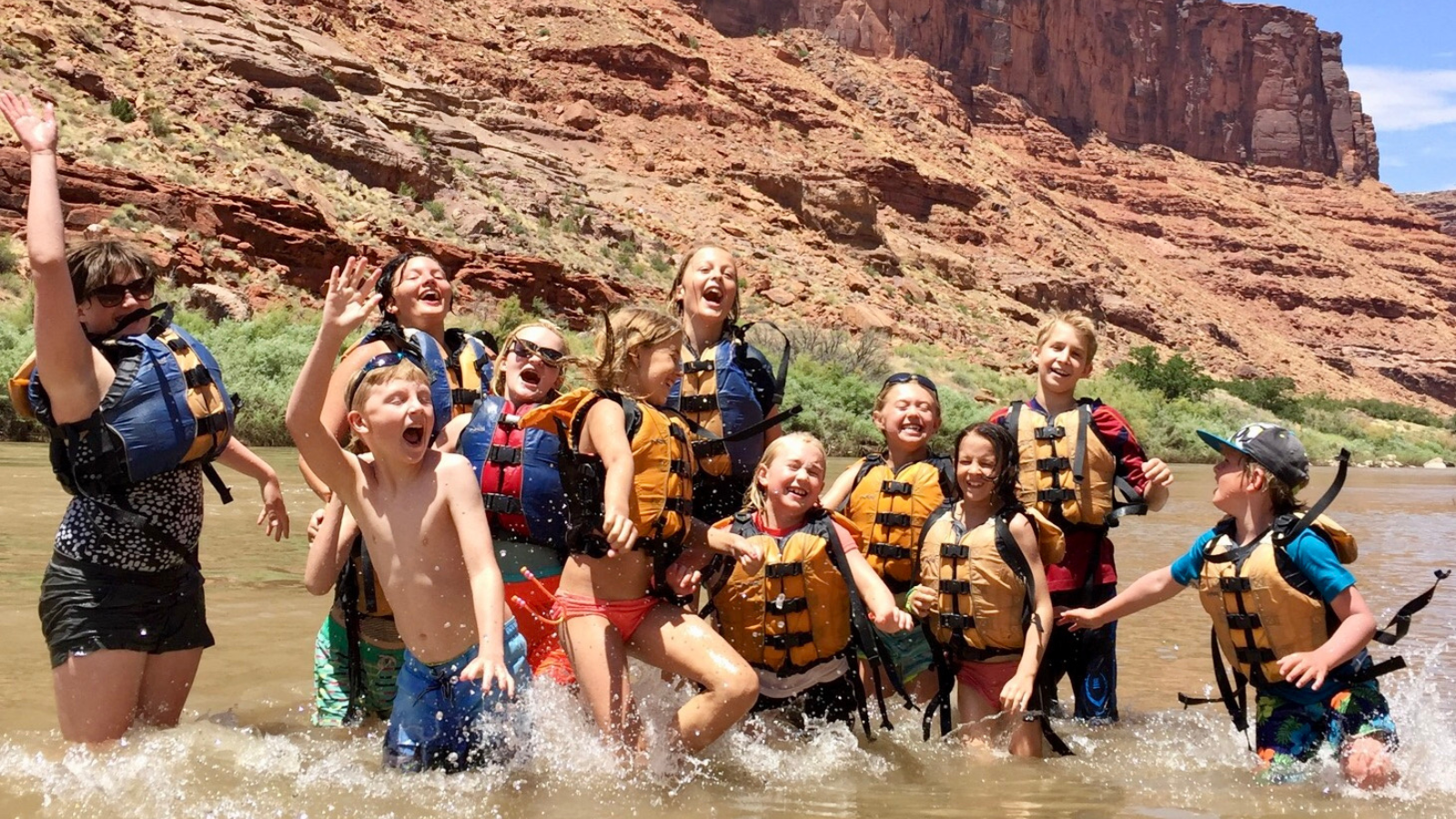 kids splash around in the river in Moab